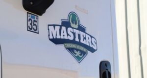 The Masters Trucking Academy logo is displayed on the side of a white truck door.